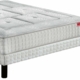 Un matelas blanc au motif texturé repose élégamment sur un cadre de lit aux pieds noirs, rappelant le style parisien chic. Canape Paris by Atelier Bis