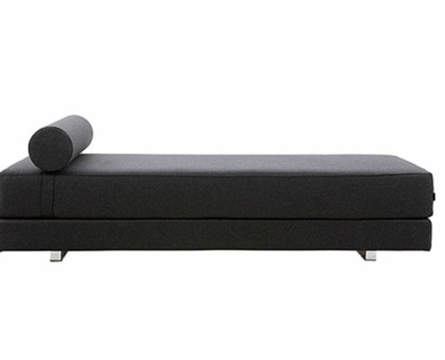 Une chaise longue noire minimaliste avec un coussin cylindrique et des pieds en métal, rappelant l'élégance parisienne, offre une qualité inégalée. Canape Paris by Atelier Bis