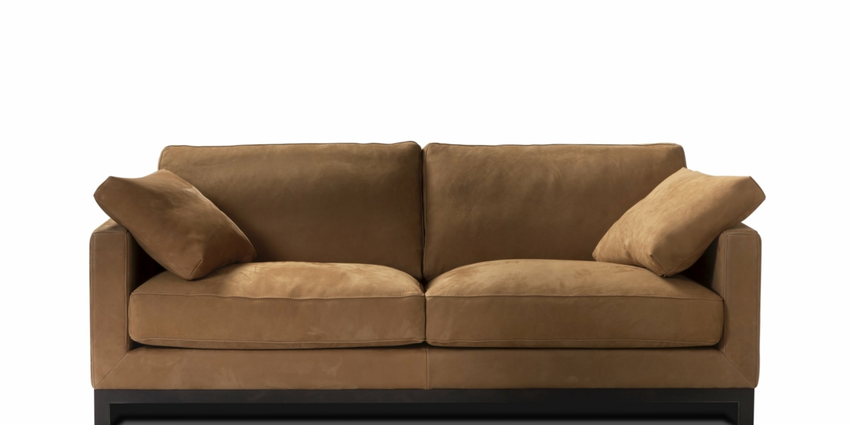 Canapé en daim marron avec deux coussins de chaque côté, posé sur un fond blanc, dégageant une élégance de qualité showroom. Canape Paris by Atelier Bis