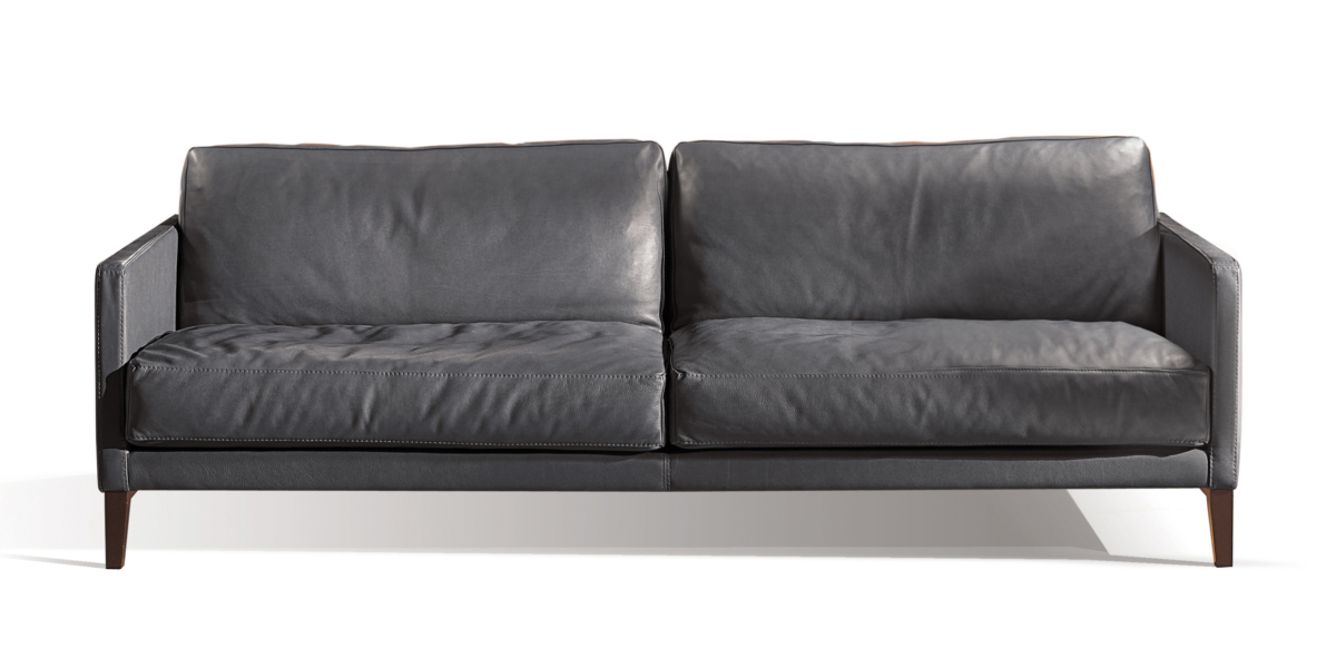 Un canapé chic et moderne en cuir gris foncé, agrémenté de deux coussins moelleux, sur fond blanc immaculé rappelant l'élégance parisienne. Canape Paris by Atelier Bis