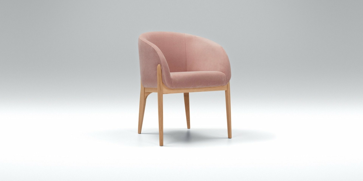 Une chaise rembourrée rose moelleuse avec des pieds en bois clair rappelant le style parisien chic repose élégamment sur un fond gris uni, évoquant un sentiment de luxe moderne semblable à un canapé douillet à un prix imbattable. Canape Paris by Atelier Bis