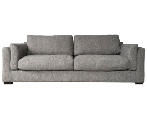 Canapé rembourré gris avec coussins épais et accoudoirs, reflétant la qualité, sur un fond blanc uni. Canape Paris by Atelier Bis