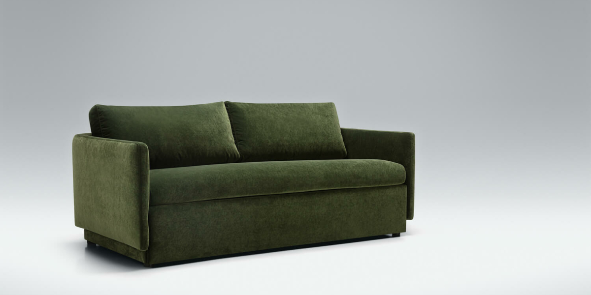 Canapé convertible en lit Colin en vert dans un salon lumineux avec des accents de beige Le canapé Colin en vert est mis en valeur dans un salon lumineux, accentué par des touches de beige pour une ambiance chaleureuse et accueillante.