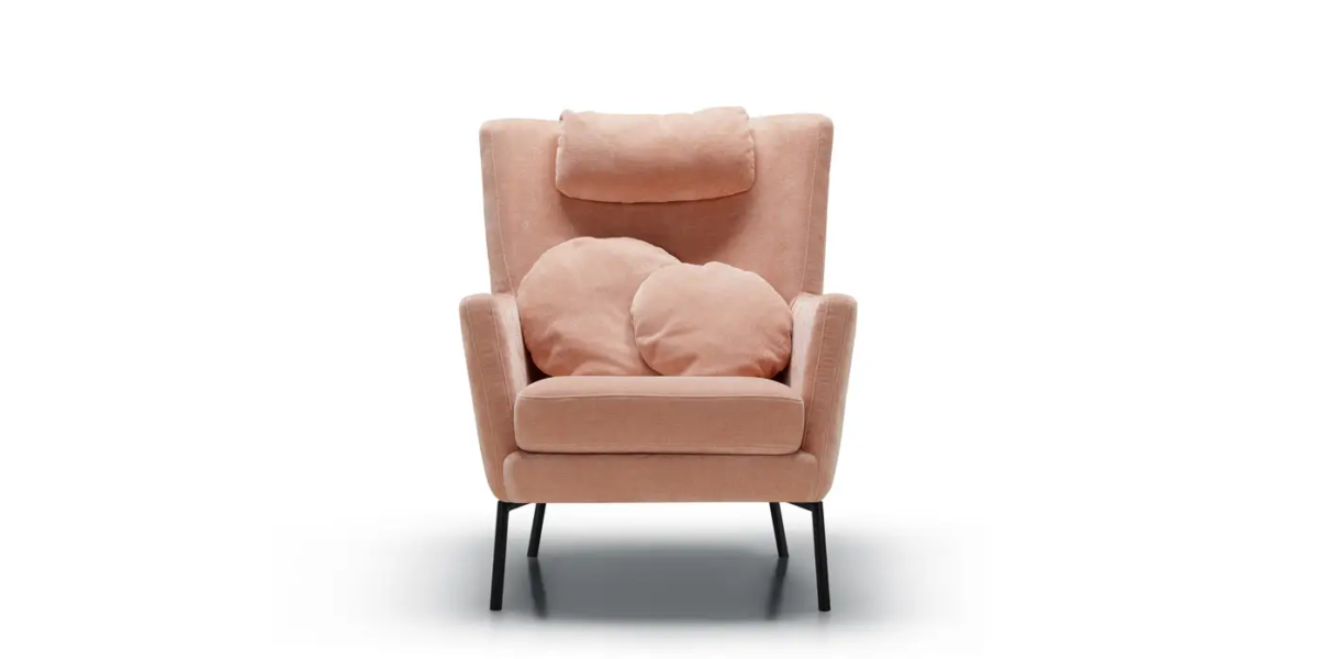 DISA_SITS_fauteuil-canape-paris_03 Fauteuil Paris avec une couverture beige posée sur le repose-pieds, devant une fenêtre ensoleillée.